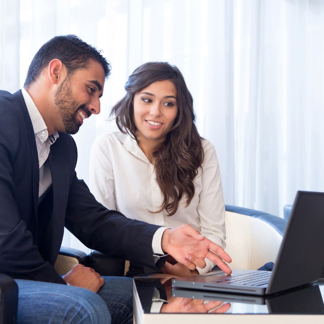 man showing coworker laptop