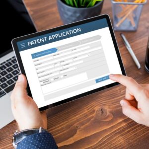 POV of someone looking at a tablet that reads "Patent Application"