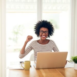 lady smiling in front of her laptop